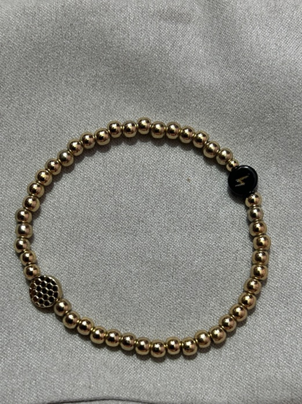 Marlyn Schiff Gold Beaded Stretch Bracelet with Black Lightning Bolt Accent NEW